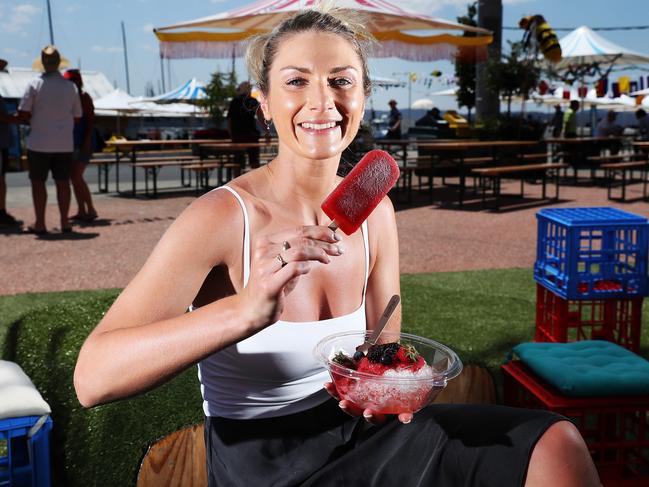 Tash Wolvers, of Melbourne, enjoys an icy pole and berry shaved ice from Chill Out Here before the Taste of Tasmania was closed because of an impending storm. Picture: NIKKI DAVIS-JONES