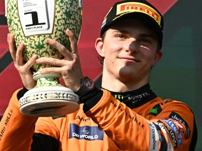 Winner Team McLaren-Mercedes' Oscar Piastri celebrates on the podium with the trophy after the Formula One Hungarian Grand Prix at the Hungaroring race track in Mogyorod near Budapest on July 21, 2024. (Photo by Attila KISBENEDEK / AFP)