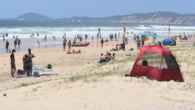 IN THE SWIM: Just part of the crowd on the beach at Rainbow Beach.