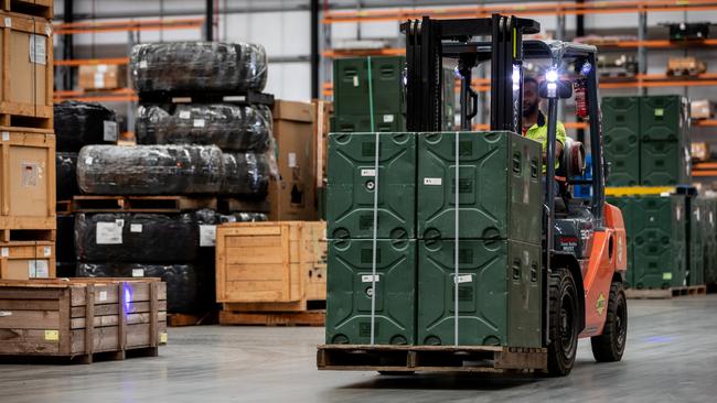 A forklift driver moves stores within the warehouse at the Joint Logistics Unit-East facility at Moorebank, NSW.