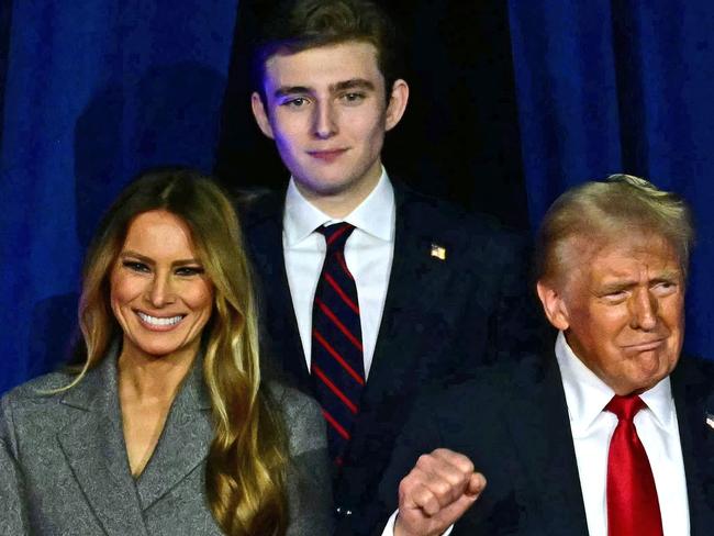 TOPSHOT - Former US President and Republican presidential candidate Donald Trump (R) arrives for  an election night event alongside former US First Lady Melania Trump and his son Barron Trump at the West Palm Beach Convention Center in West Palm Beach, Florida, on November 6, 2024. (Photo by Jim WATSON / AFP)