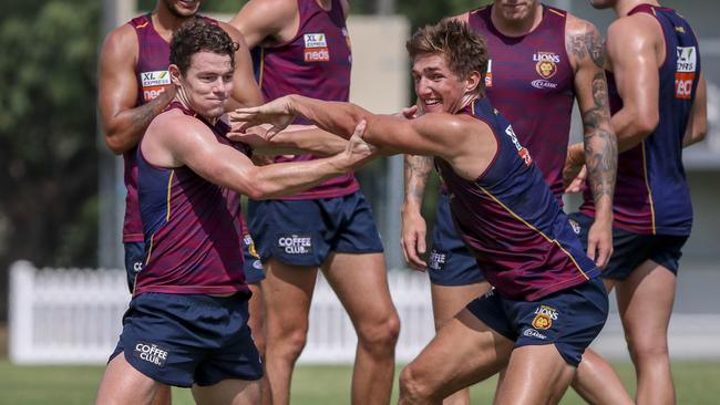 Lachie Neale, left, and draftee Deven Robertson compete for the ball at Brisbane training. Picture: Glenn Hunt/AAP