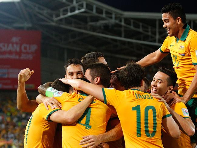 SYDNEY, AUSTRALIA - JANUARY 13: Matt McKay of Australia celebrates with team mates after scoring a goal during the 2015 Asian Cup match between Oman and Australia at ANZ Stadium on January 13, 2015 in Sydney, Australia. (Photo by Brendon Thorne/Getty Images)