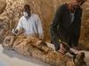 Egyptian archaeological technicians restore a mummy wrapped in linen, found at the newly discovered "Kampp 150" tomb at Draa Abul Naga necropolis on the west Nile bank of the southern Egyptian city of Luxor, about 650 kilometres (400 miles) south of the capital Cairo, on December 9, 2017. / AFP PHOTO / STRINGER