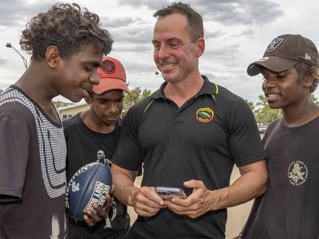 Alice Springs based Yipirinya School principal Gavin Morris on the school grounds with Malikai Hayes, Keylin Peters (red cap), Adrian Nelson (black cap). Picture: Grenville Turner