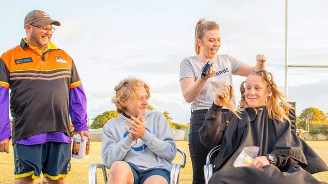 Chris Auguston watch as his son Jack Auguston, 15, left, and Donovan Ryan-Ellul, 15, had their hair shaved off by Amanda Rafferty to raise $4000 for the Mackay and Pioneer Valley Relay at the Wests Rugby Leagues Club, on Saturday September 12.