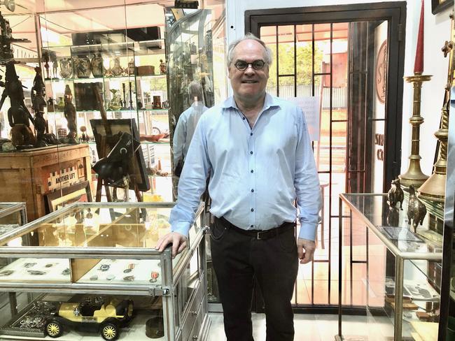 Mark Duff poses with the controversial Nazi memorabilia in Cafe Lautrec, Paddington