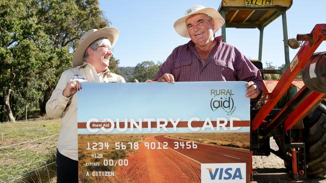 Farmer Craig Murphy gets his Visa gift card from Rural Aid’s Julia Hahn.