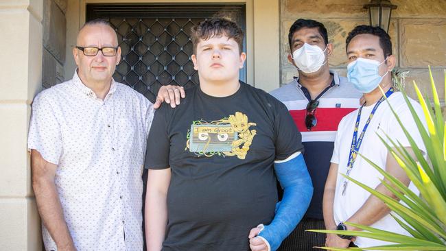 Chad, with stepfather Stjepan (left) and disability carers Lucky and Male (right), at home in the Riverland. Picture Emma Brasier.