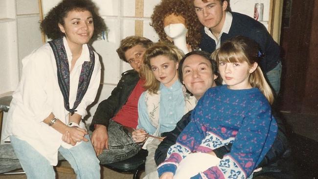 Smug smile of a sick man: Robert Hughes with the Hey Dad! cast, and victim Sarah Monahan on his lap.