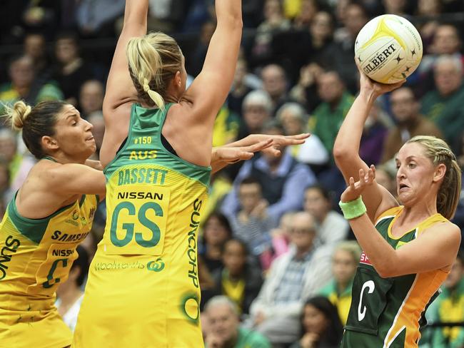 Erin Burger fights for the ball with Caitlin Bassett (centre) and Kim Ravaillion.