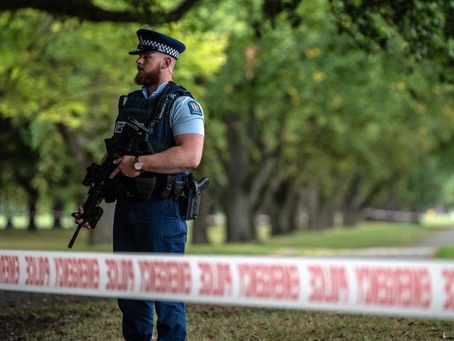 A police officer carrying an automatic rifle guards the area near Al Noor mosque. Picture: Getty