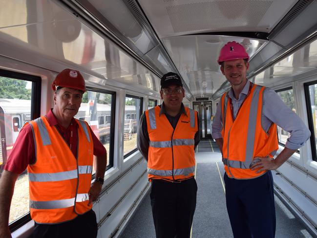 Transport Minster Mark Bailey and Maryborough member Bruce Saunders (right) with head of growth and development Downer Andrew Spink (centre) in one of the NGR trains to be repaired.