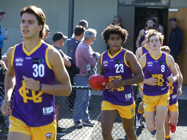 Oakleigh Chargers, wearing a heritage VFA strip, run out onto Warrawee Park Oval. Picture: Stuart Milligan