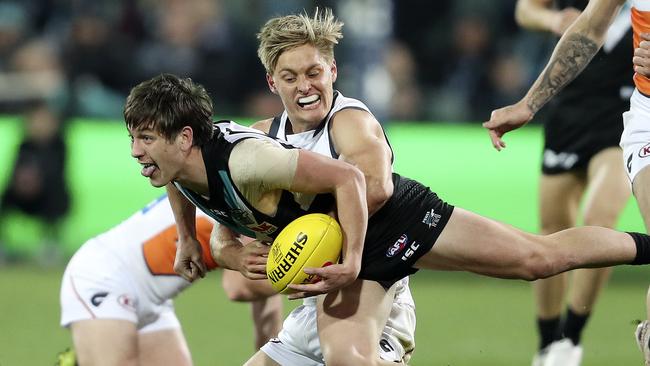 Jackson Hately tackles Port Adelaide’s Zac Butters at Adelaide Oval during his debut season of 2019. Picture: Sarah Reed.