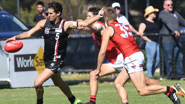 Will Fordham gets a kick away just in time against Essendon.