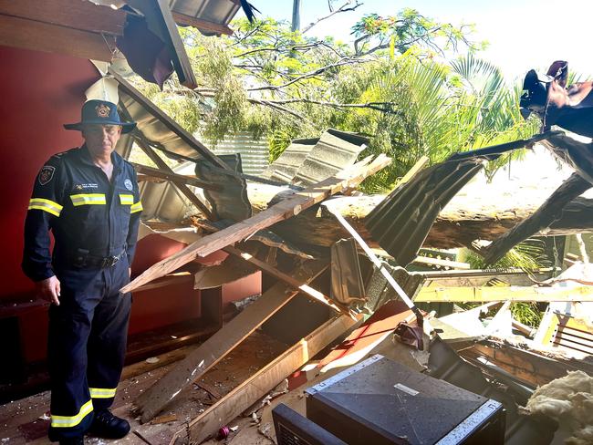 Queensland Fire and Rescue Service officer Dale McVeigh inspects damage to the home of Lucie Simmons and Michael Meudell in Helensvale. Picture: Keith Woods.