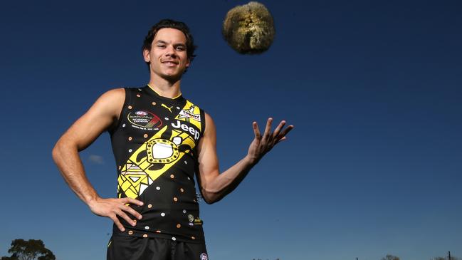 Daniel Rioli dons this year’s jumper, with a traditional Marngrook made of possum skin. Picture: David Caird