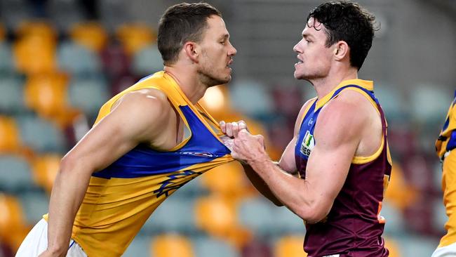 Jack Redden (left) of the Eagles is grabbed by Lachie Neale.