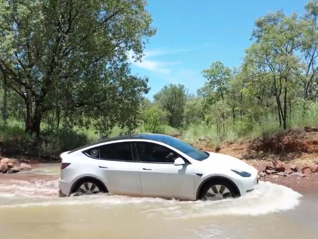 The Tesla Y taking on a flood affected bit of road on Mr Murphy's trip. Picture: Twitter