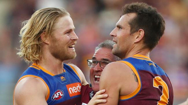 Daniel Rich celebrates a recent win with two other experienced finals campaigners — Luke Hodge and coach Chris Fagan. Picture: Chris Hyde/Getty Images.