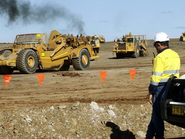 An engineer watches as Earthmovers carve out the runway  as works continue at the Badgery's Creek Construction site of the Western Sydney Airport. Picture: John Appleyard