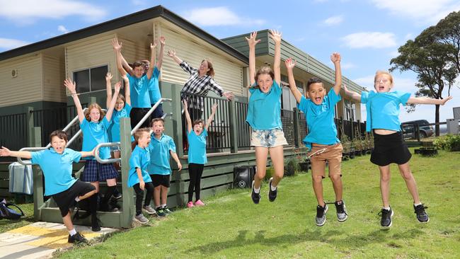 Students Ruby, 9, Kade, 6 and Aimee, 8, Joey, 5, Declan, 8, Lilly, 8 Revan, 9, Emma, 11, Annika, 9, Jake, 11, and Brendan, 11, with their principal Sue Paul are happy to return to school for the first day. Picture: Alex Coppel.