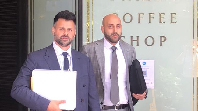 Dentist James Mina Hanna (right) leaves court with his legal team.