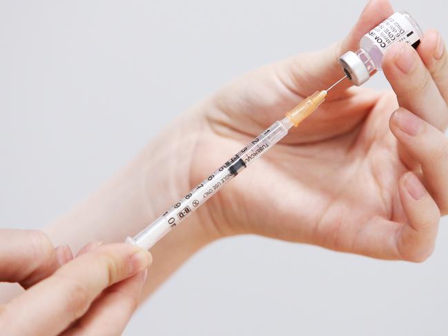 SYDNEY, AUSTRALIA - JULY 01: A staff member prepares a Pfizer vaccine for clients at the St Vincent's Covid-19 Vaccination Clinic on July 01, 2021 in Sydney, Australia. Much of Australia is in lockdown or subject to some form of restriction as community cases of the COVID-19 Delta variant continue to be recorded around Australia. Currently, the Pfizer vaccine is available to frontline workers, people with pre-existing health conditions and people in their 40s and 50s, while the AstraZeneca vaccine is recommended for people over 60. Prime Minister Scott Morrison on Monday announced an indemnity scheme for general practitioners, saying anyone could receive AstraZeneca at a GP clinic despite vaccine advisory group ATAGI recommending Pfizer as the preferred vaccine for those under 60. (Photo by Lisa Maree Williams/Getty Images)