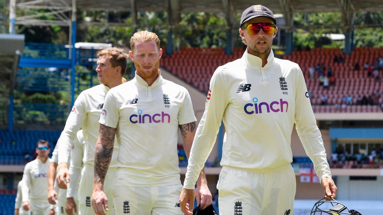 Joe Root (R) and Ben Stokes (2R) of England walk off the field after being defeated by the West Indies. Photo: AFP