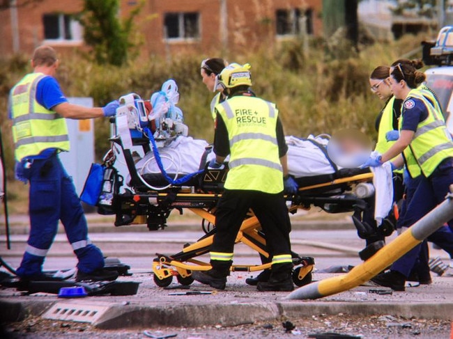 One the injured men is stretchered into an ambulance. Picture: Sam Ruttyn