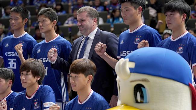 Yokohama F Marinos new head coach Ange Postecoglou of Australia poses with new players during a press conference in Yokohama