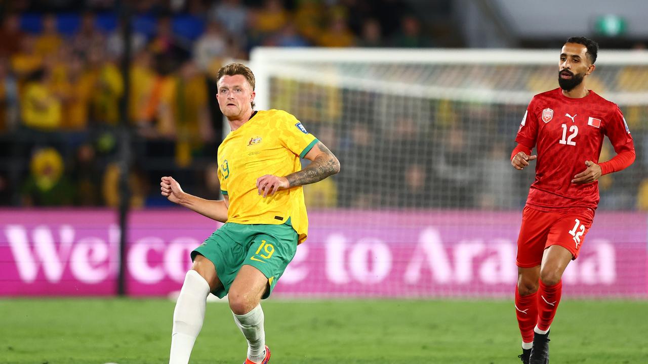 Harry Souttar (right) passes the ball during the Socceroos’ 1-0 loss Indonesia. Picture: Chris Hyde/Getty Images