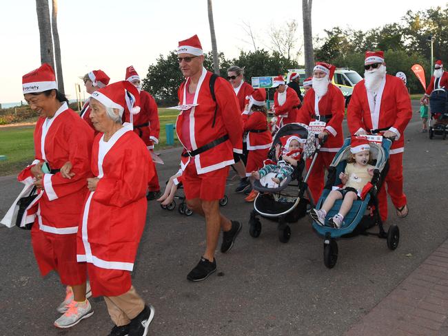 Participants set off for the Darwin Santa Fun Run in July at Mindil Beach. Picture Katrina Bridgeford