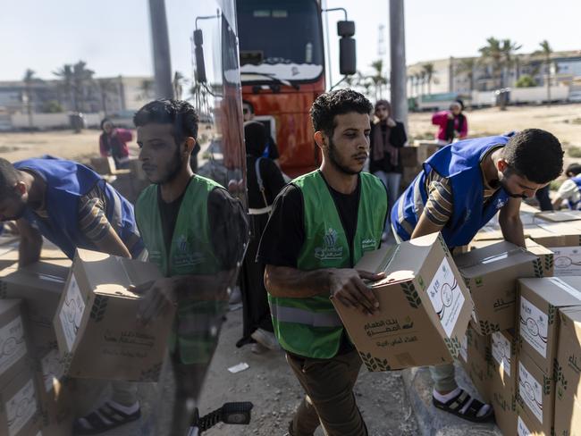 Volunteers load food and supplies onto aid convoy trucks for Gaza in North Sinai, Egypt. Picture: Mahmoud Khaled/Getty Images