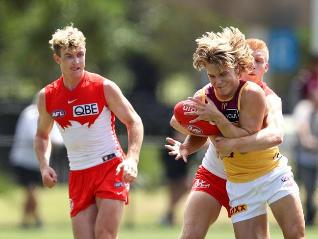 Lions midfielder Will Ashcroft (front right) competes with Sydney’s Jordan Dawson. Picture: Brendon Thorne/Getty Images