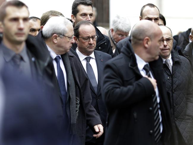 French President Francois Hollande (C) arrives at the headquarters of the French satirical newspaper Charlie Hebdo in Paris. Picture: AFP