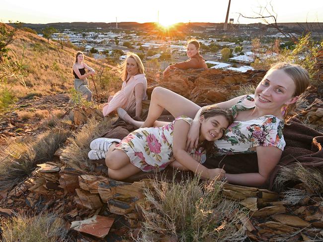 07/12/2021: Lifelong Mount Isa locals  (foreground) Phoebe Ryder 20 , with her niece Gabrielle Ryder 6, watched by mum (and city councillor)  Kim Coghlan 58, and (GabrielleÃ¢â¬â¢s mum in brown) Gracie Ryder 24 and  (in black) Zoe Ryder 15,  on a hill in the centre of town overlooking the mine. Locals and workers are concerned at the potential social effects of the mines planned change to a permanent 7 day on, 7 day off roster.  Lyndon Mechielsen/The Australian