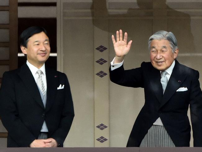 This file photo taken on January 2, 2015 shows Japan's Emperor Akihito (R) waving to wellwishers while Crown Prince Naruhito (L) looks on. Picture: AFP.