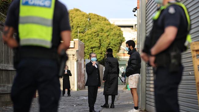 Police and onlookers outside the synagogue in Ripponlea. Picture: Mark Stewart