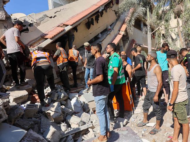 Emergency crews look for survivors following an Israeli air strike at a Gaza school. Picture: AFP