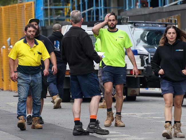 Shocked workers find out more about Probuild’s collapse. Picture: Ian Currie.