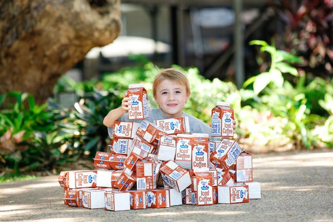 Beau Canel,l 6, with empty Paul’s iced coffee containers ahead of this years Beer can Regatta. Pic Glenn Campbell