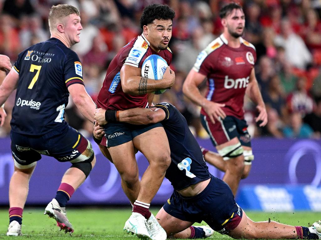 BRISBANE, AUSTRALIA - APRIL 19: Hunter Paisami of the Reds takes on the defence during the round nine Super Rugby Pacific match between Queensland Reds and Highlanders at Suncorp Stadium, on April 19, 2024, in Brisbane, Australia. (Photo by Bradley Kanaris/Getty Images)