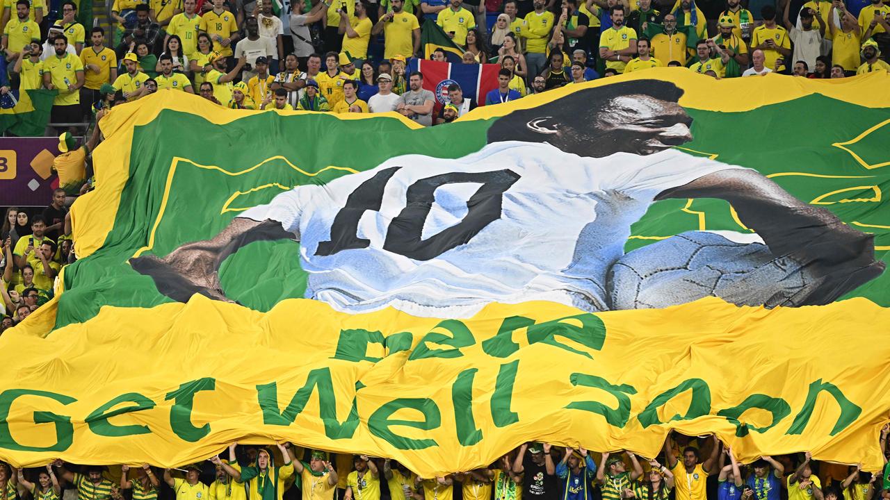 Brazil supporters display a banner depicting Brazilian football legend Pele and reading "Pele, get well soon".