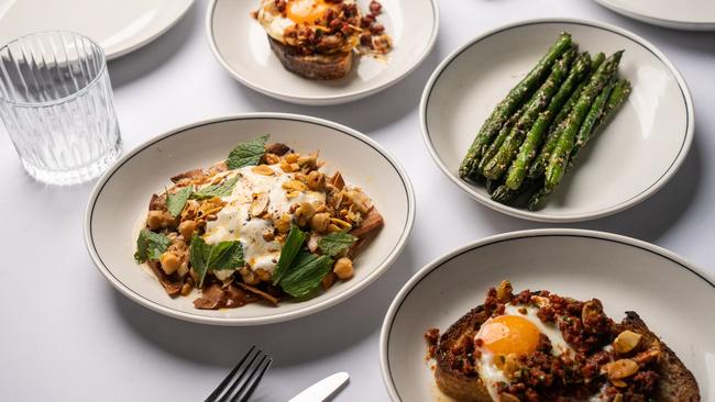 Four-course feast: smoked trout fattet, asparagus with za'atar and toum, fried egg with sujuk and almonds on Baker Bleu sourdough