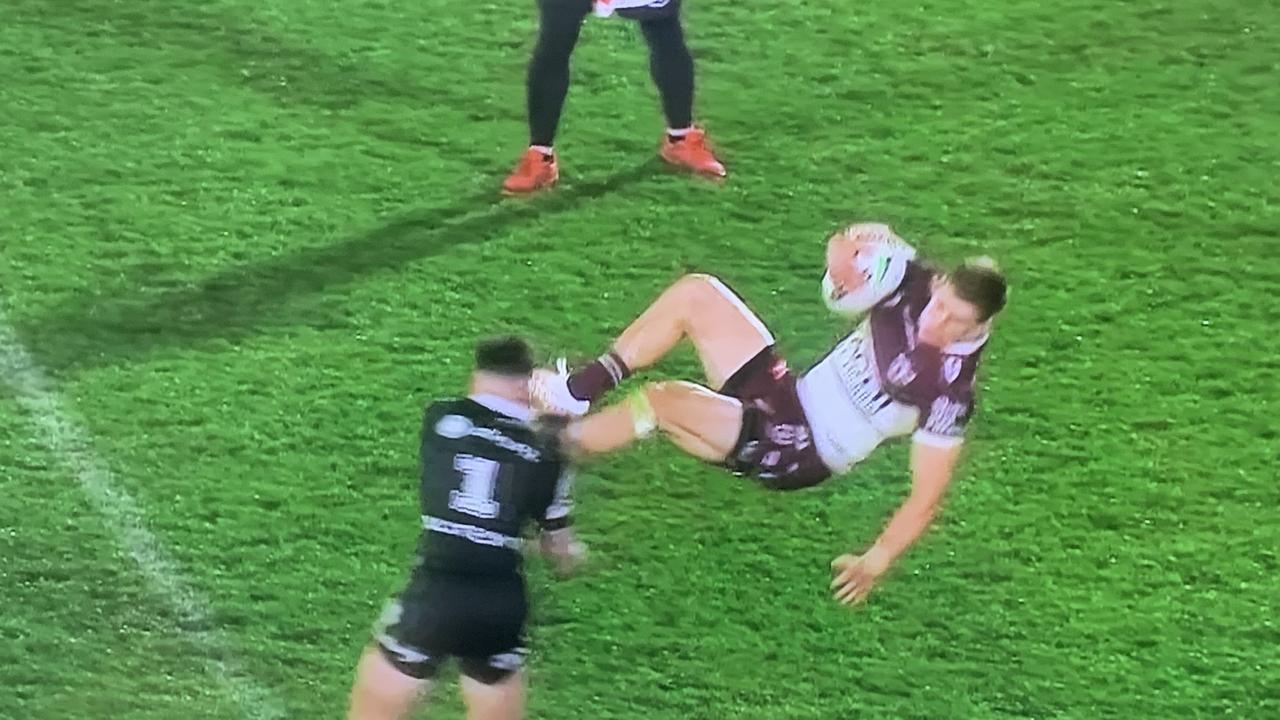 Manly’s Reuben Garrick is flipped in a tackle by Charnze Nikoll-Klokstad in Auckland last night.