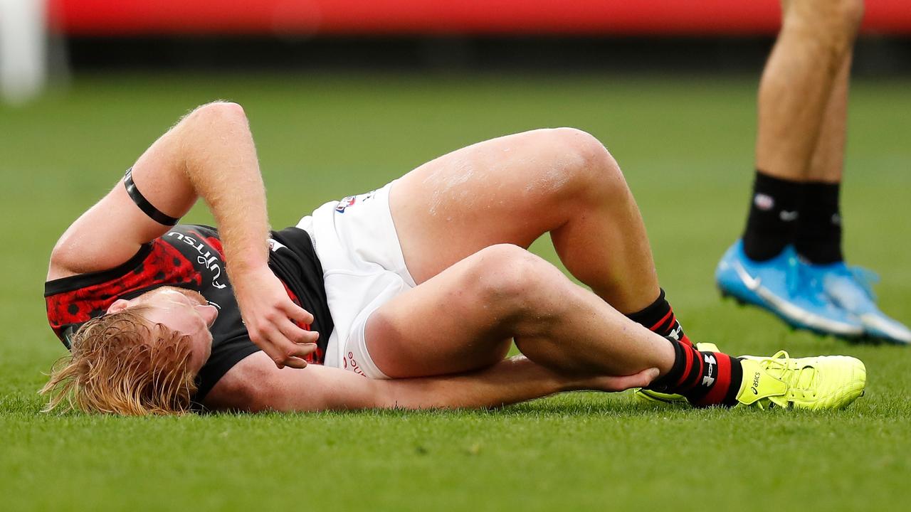 Aaron Francis lies on the MCG turf after going down with an ankle injury.