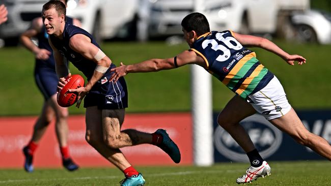 VAFA: Old Melburnians’ Edward Nichols escapes St Kevin’s Liam Gunson. Picture: Andy Brownbill