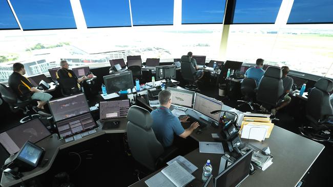 Air traffic controllers in the control tower for Airservices Australia, above Brisbane Airport. Picture: Lyndon Mechielsen/The Australian